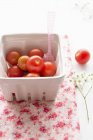 Cherry tomatoes in cardboard punnet — Stock Photo