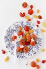 Red and yellow tomatoes with blossom — Stock Photo