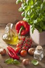 An arrangement of vegetables, spices, basil and olive oil — Stock Photo