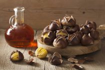 Roasted chestnuts and sea buckthorn syrup — Stock Photo