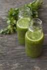 Green smoothies on table — Stock Photo