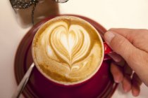 F cup of Cappuccino with heart — Stock Photo