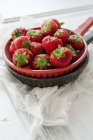 Fresh strawberries in sieve — Stock Photo