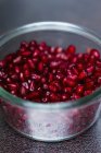 Pomegranate seeds in glass jar — Stock Photo