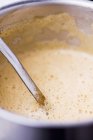 Closeup view of chanterelle mushroom foam in a pot with a ladle — Stock Photo