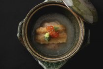 Closeup top view of eel in broth with caviar — Stock Photo