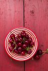Cherries on stripped plate — Stock Photo