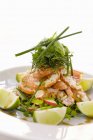 Pesto-baked scampi with dill and limes on white plate — Stock Photo