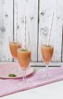 Three rhubarb drinks with straws in glasses — Stock Photo