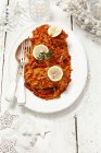 Fish with vegetables in tomato sauce — Stock Photo