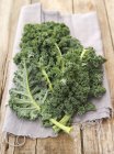Green kale on linen cloth — Stock Photo