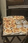 Close up of Dinnede (mini tarte flambe) at a market — Stock Photo