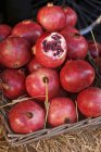 Basket of fresh pomegranates — Stock Photo