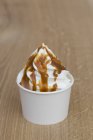 Frozen yogurt with caramel sauce — Stock Photo