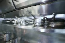 Closeup view of blurred pots and pans in a kitchen — Stock Photo