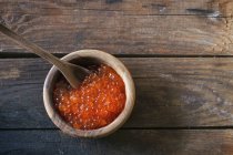 Red caviar in wooden bowl — Stock Photo