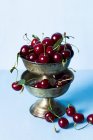 Cherries in old silver vase — Stock Photo