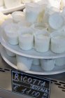 Ricotta on stand in shop — Stock Photo