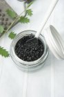 Black salt in a screw-top jar — Stock Photo
