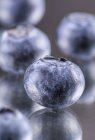 Fresh Blueberries on mirror — Stock Photo