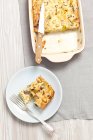 Mushroom and leek bake, sliced on white plate and in dish over towel — Stock Photo