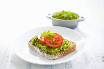 Slice of bread topped with pea — Stock Photo