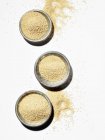Top view of Amaranth in three bowls and on white surface — Stock Photo