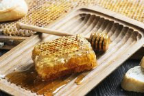 Honeycomb with honey spoon — Stock Photo