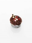 Cupcake decorated with chocolate cream — Stock Photo