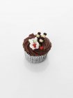 Cupcake decorated with chocolate cream — Stock Photo