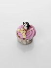 Cupcake decorated with cream and penguin — Stock Photo