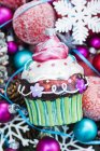 Bauble cupcake on Christmas decorations — Stock Photo