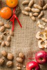 Fruits and mixed nuts creating frame — Stock Photo