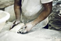 Baker kneading bread — Stock Photo