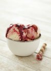 Closeup view of icecream with raspberry sauce and a wafer cigar — Stock Photo