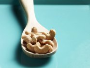 Cashew nuts in wooden spoon — Stock Photo