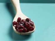 Dried cranberries on wooden spoon — Stock Photo