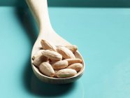 Shelled almonds on wooden spoon — Stock Photo