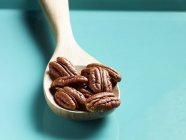 Орехи пекан на деревянной ложке — стоковое фото