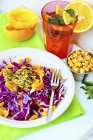 Closeup view of red cabbage salad with oranges and pumpkin seeds — Stock Photo