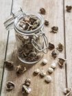 Closeup view of Moringa seeds in a jar on a wooden surface — Stock Photo
