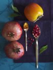 Pomegranates with persimmon and turmeric — Stock Photo