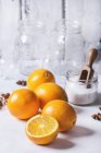 Fresh oranges and jar with sugar — Stock Photo