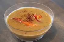 Closeup view of lobster Bisque creamy soup in glass bowl — Stock Photo