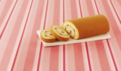 Closeup view of sliced Swiss roll with strawberry cream — Stock Photo