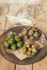 Marinated olives in metal lids — Stock Photo