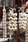 Strings of garlic bulbs — Stock Photo