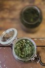 Closeup top view of a dried herbal mixture in a preserving jar — Stock Photo