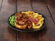 Cumberland sausage with bacon — Stock Photo