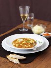 Bouillabaisse with ciabatta and cheese — Stock Photo